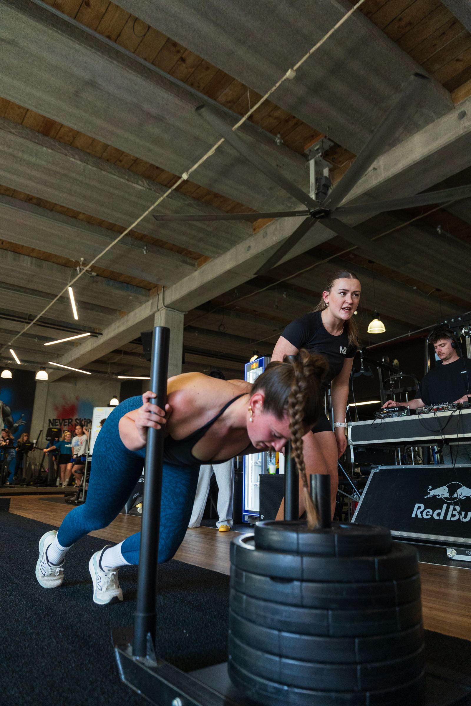 Members pushing sleds in a group class at M2